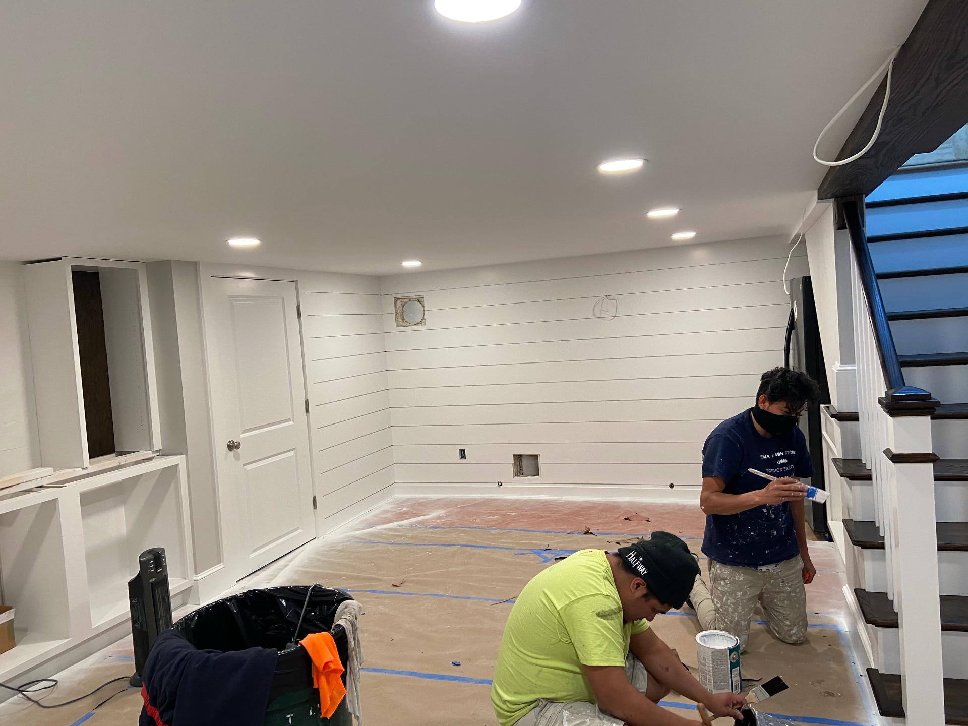 Lima Painting crew painting finished basement with shiplap walls and built-ins in Greater Boston MA