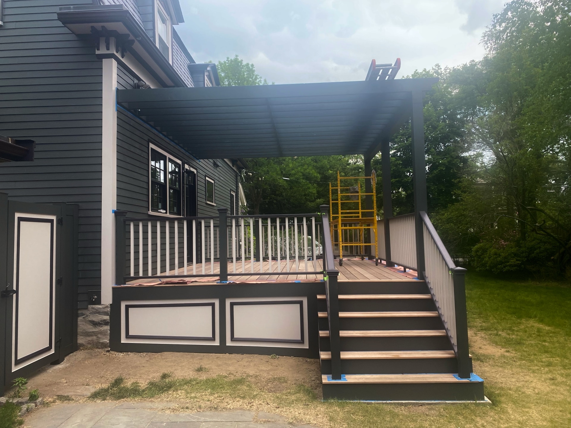 reshly painted deck and pergola with charcoal and white trim by Lima Painting in Greater Boston MA