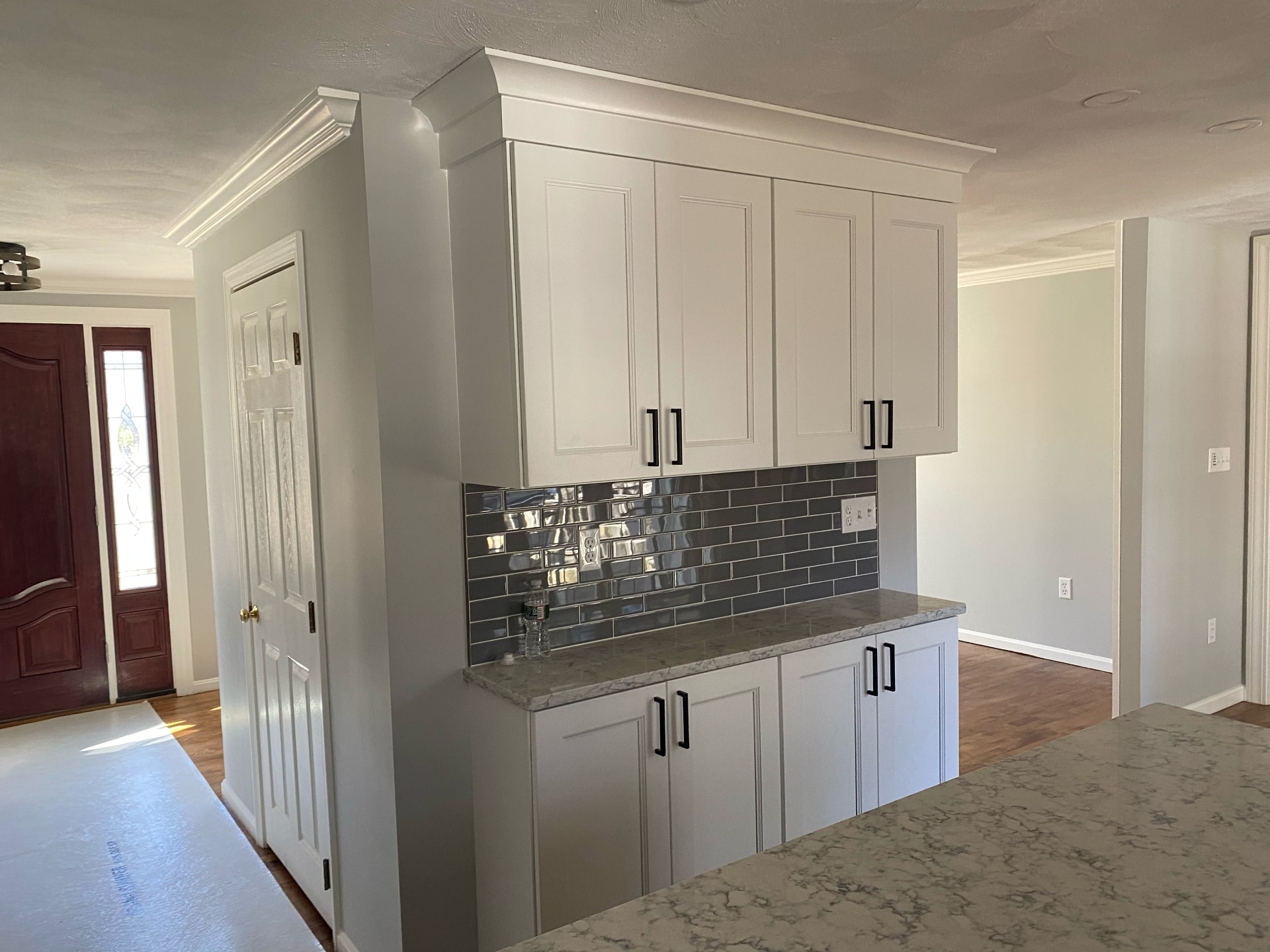 Painted kitchen cabinets and interior walls with crown molding by Lima Painting in Greater Boston MA