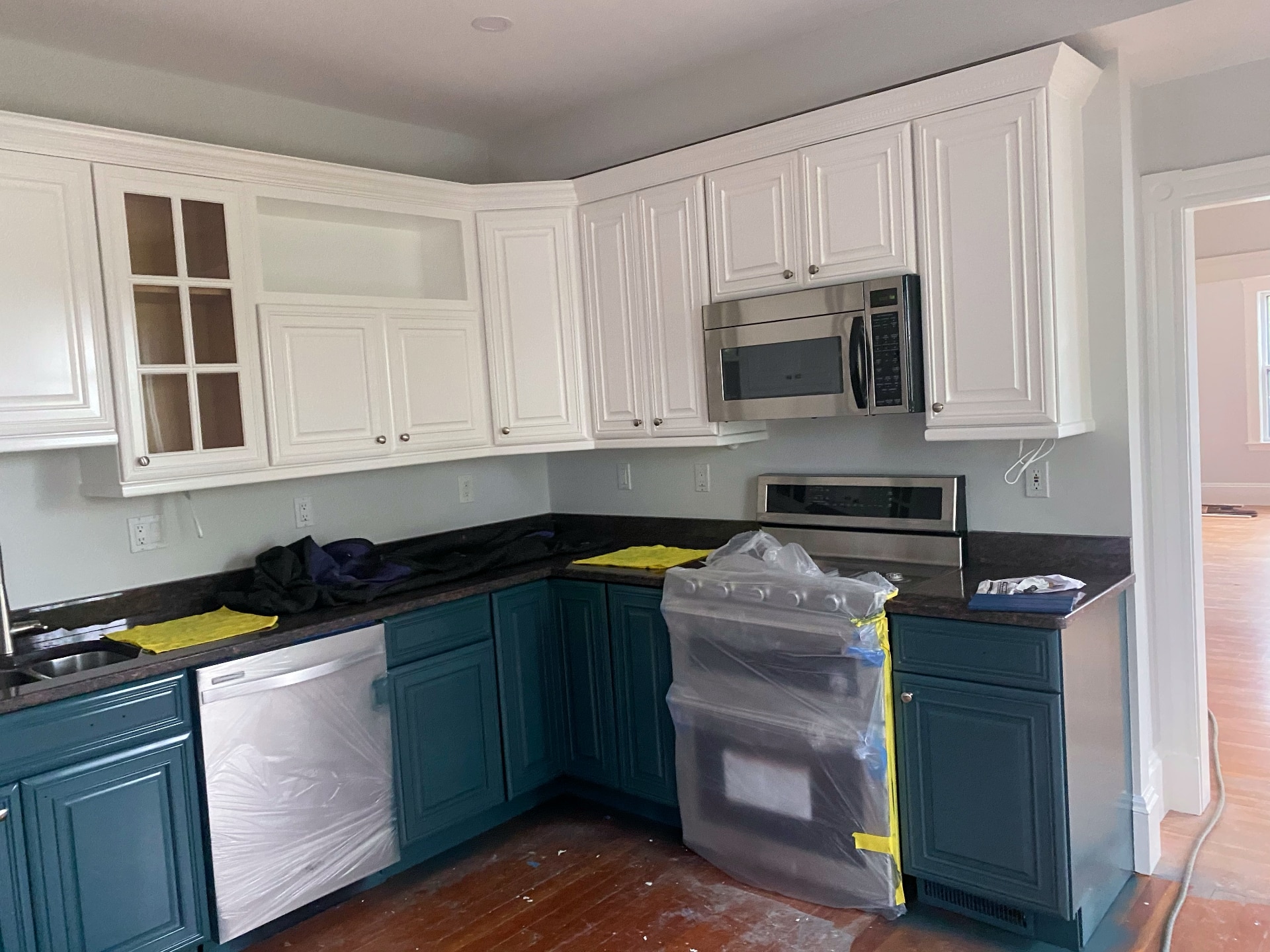 Two-tone kitchen cabinet painting with white upper and teal lower cabinets by Lima Painting in Greater Boston MA