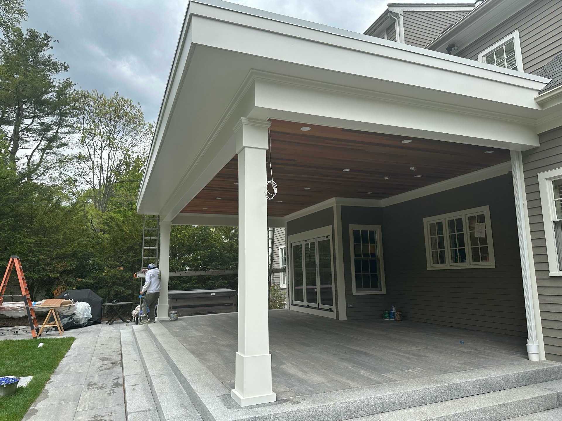 Lima Painting crew painting exterior patio cover and home exterior in Greater Boston MA