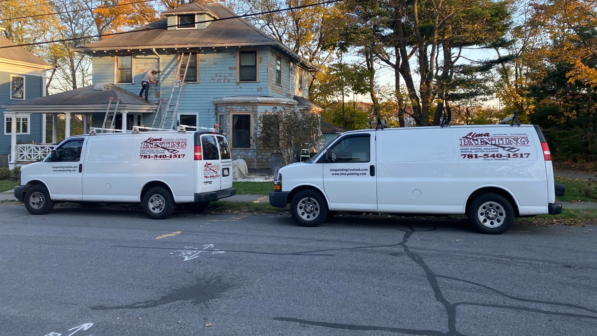 Lima Painting work vans parked outside a home exterior painting project in Greater Boston MA